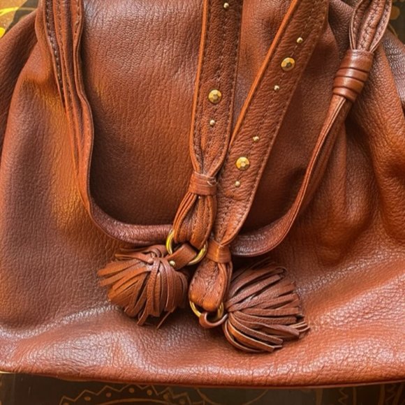 This is a Sigrid Olsen leather purse with tassles and goldtone hardware. - Picture 1 of 9